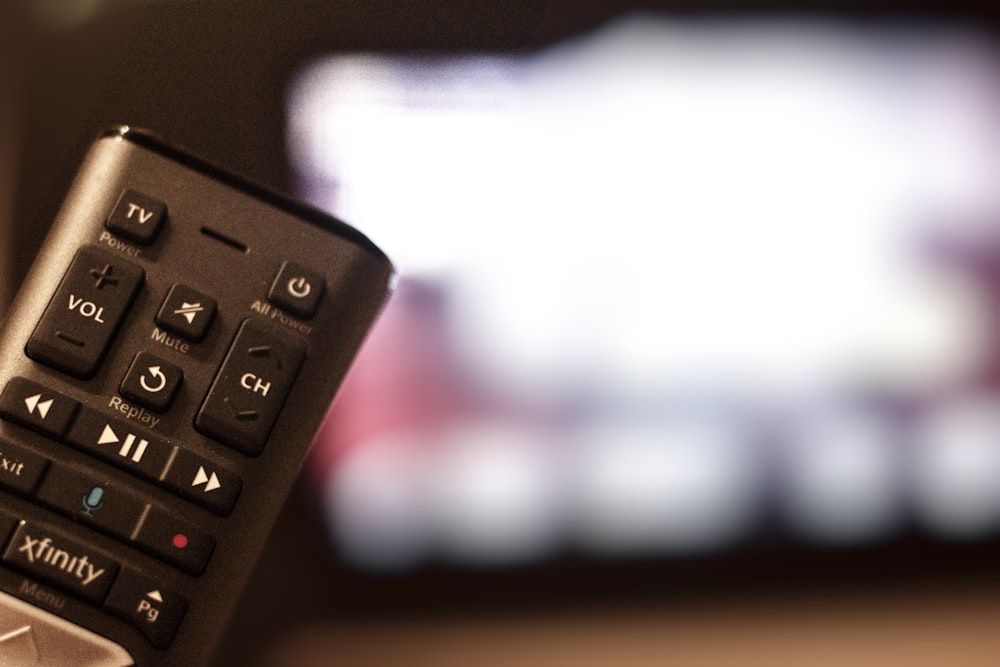 black remote control on brown wooden table