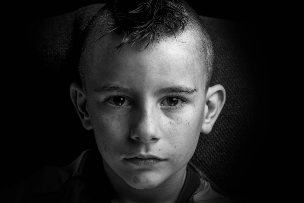 grayscale photo of boy in collared shirt