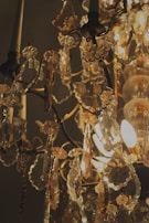 A sparkling crystal chandelier hanging above a dining table, reflecting soft light.