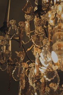 A sparkling crystal chandelier hanging above a dining table, reflecting soft light.