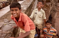 Children playing in a hospital garden, showcasing joy amidst challenges.