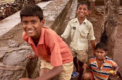 Smiling children playing together outdoors in a supportive environment.
