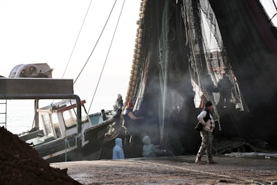 A close-up of a fisherman preparing his nets on a dock.