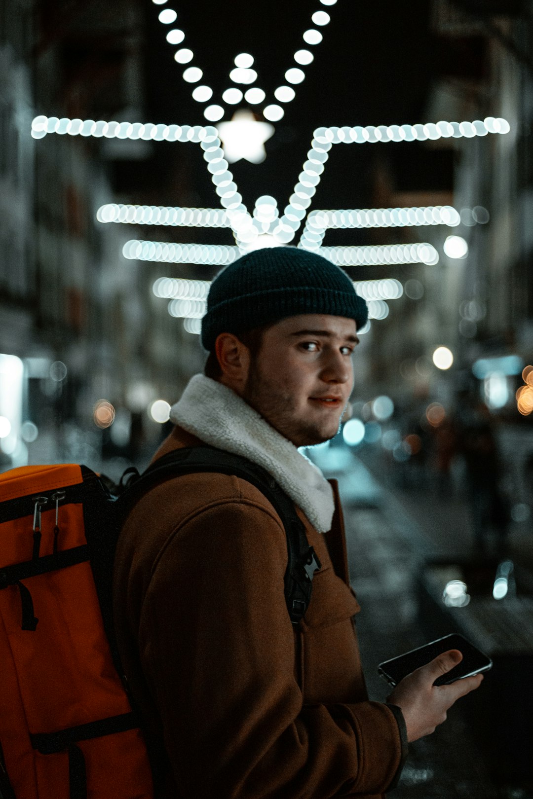 man in brown jacket and gray knit cap