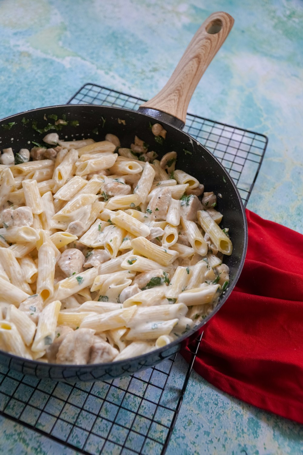 black frying pan with pasta