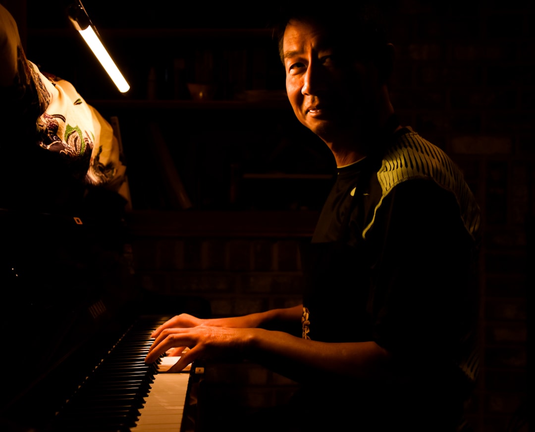 man and woman standing beside piano