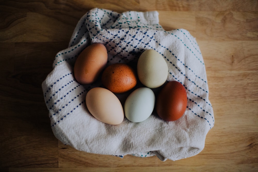 brown egg on white textile