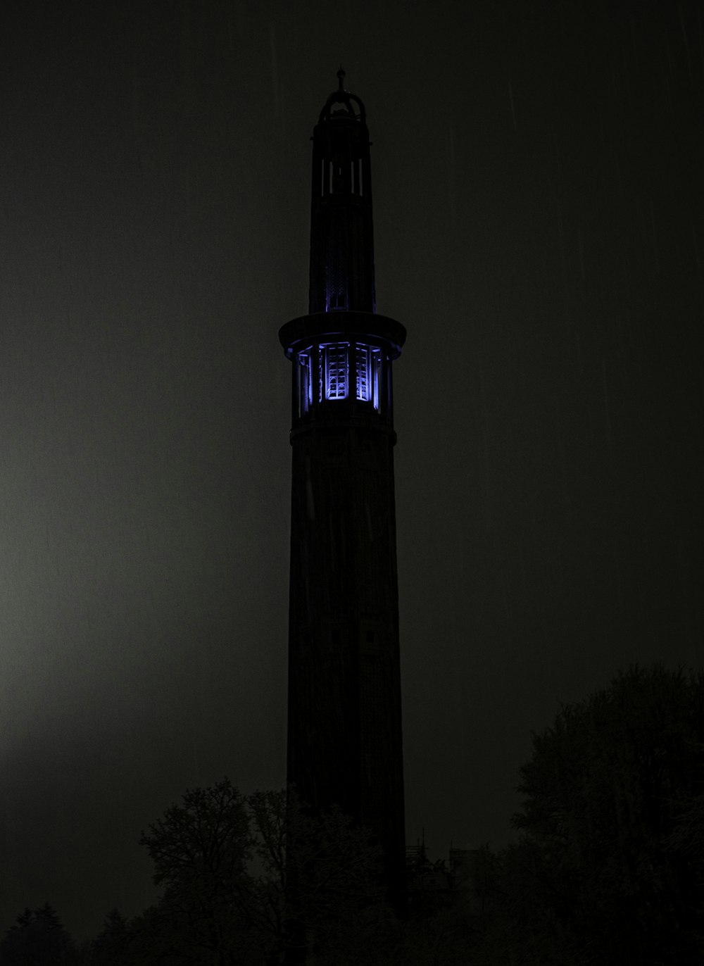 silhouette of tower during night time