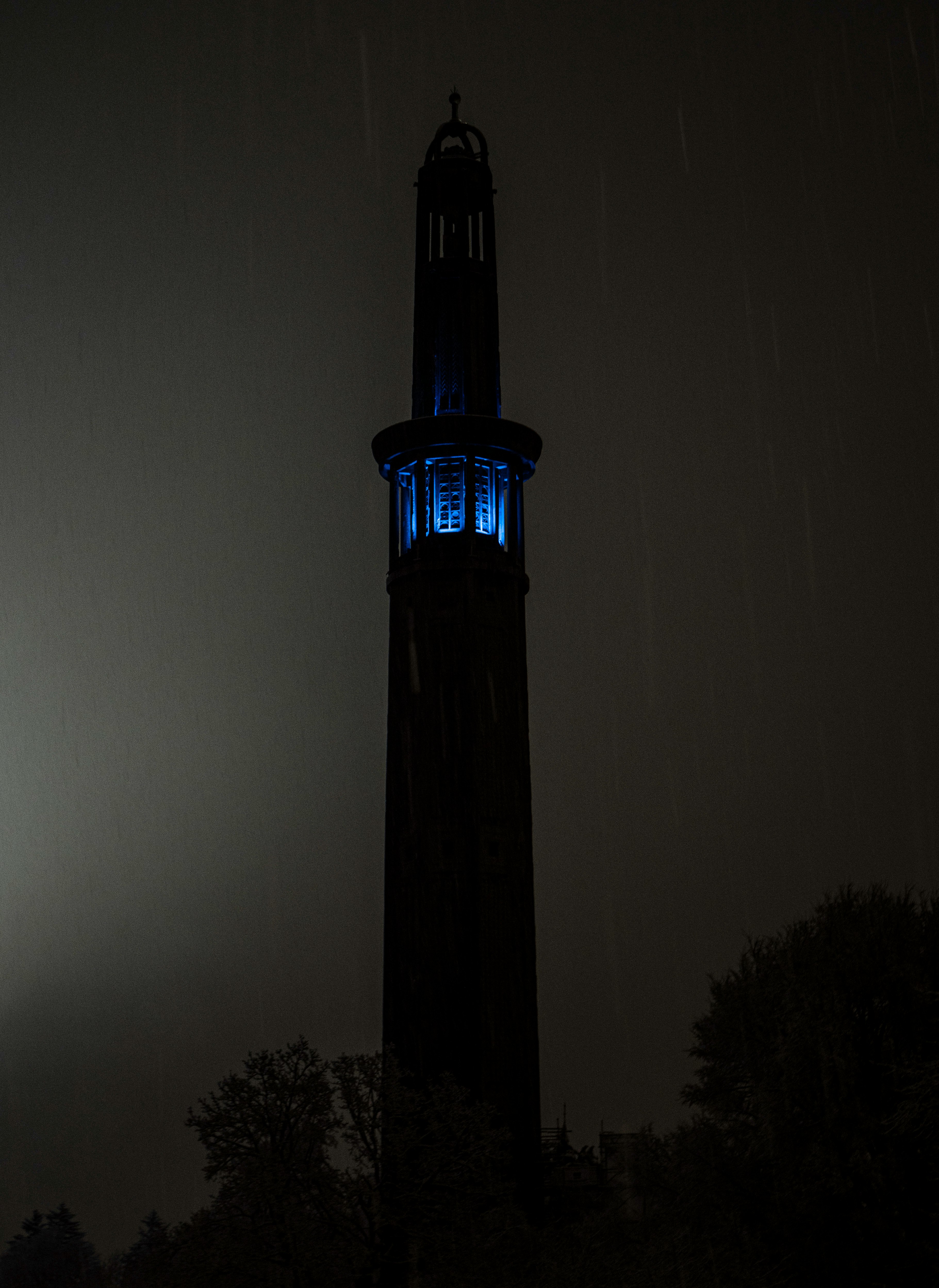 silhouette of tower during night time