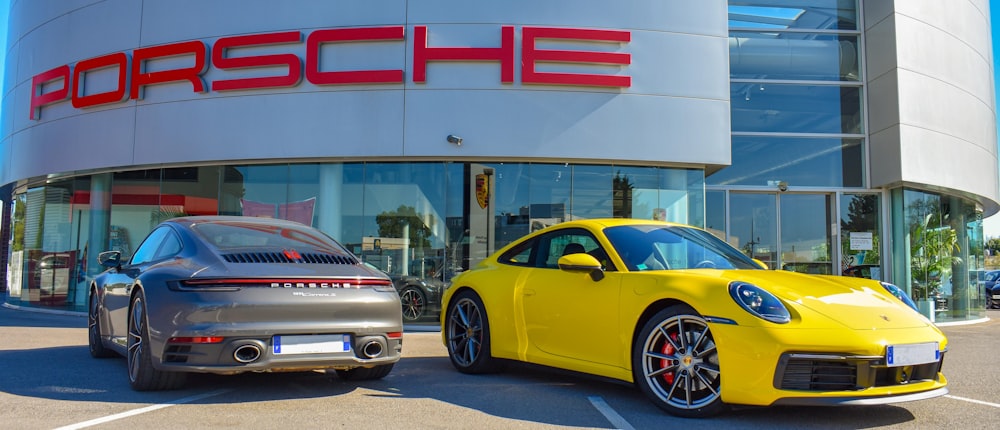 yellow porsche 911 parked in front of white and red building