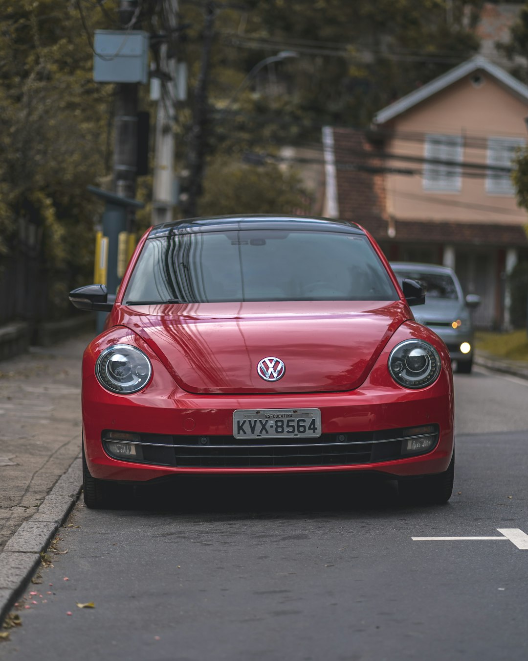 red volkswagen car parked on the street during daytime