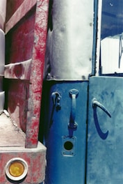 Close-up of a car's rear door with visible dents and scratches before repair.