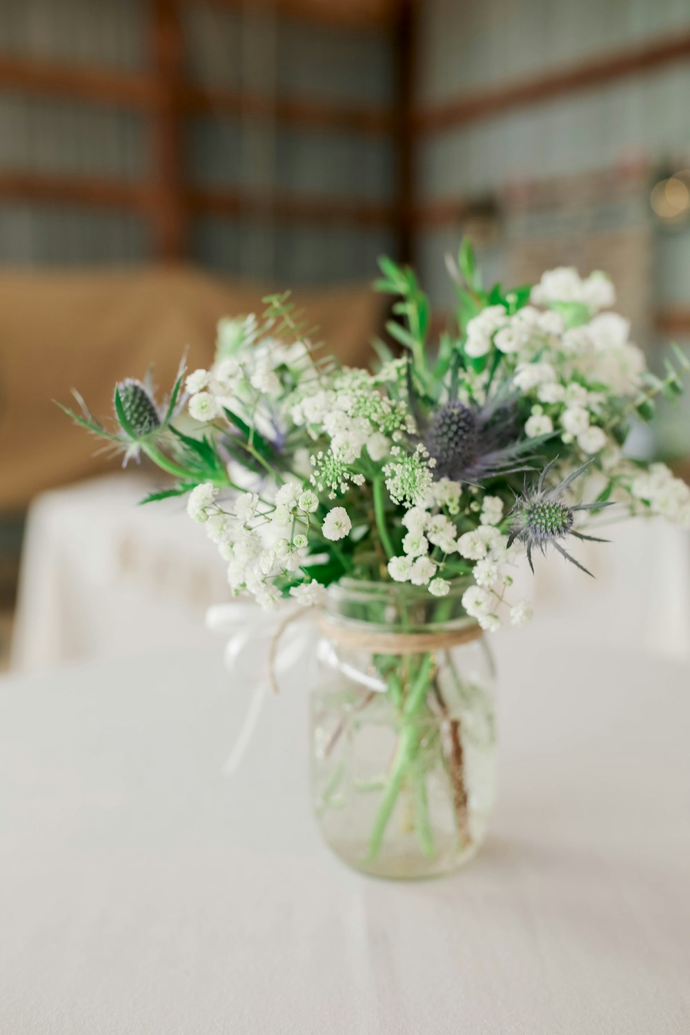 white and purple flowers in clear glass vase