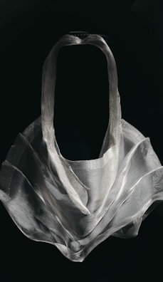 A sculpture piece made of layered translucent materials casting intricate shadows.