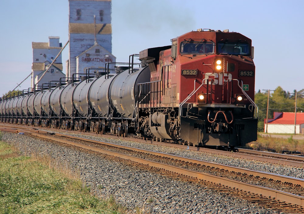 red and brown train on rail tracks during daytime