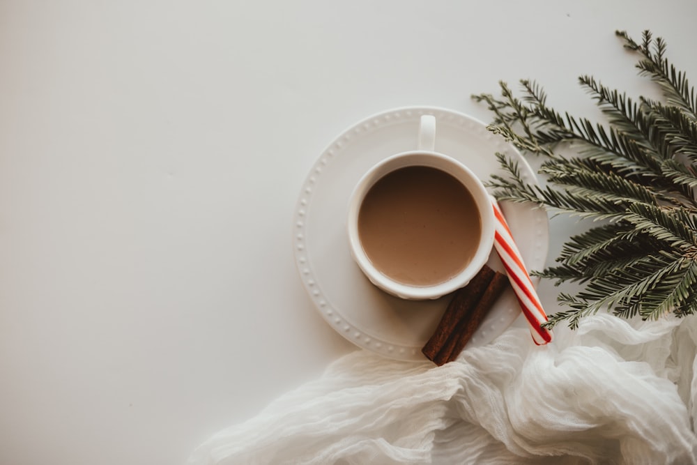 white ceramic mug on white fur textile