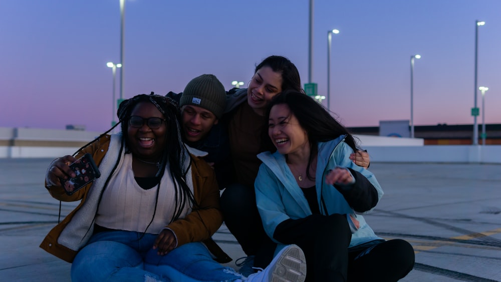 3 women and 2 men sitting on boat during daytime