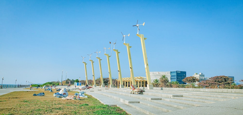 white wind turbines on green grass field under blue sky during daytime