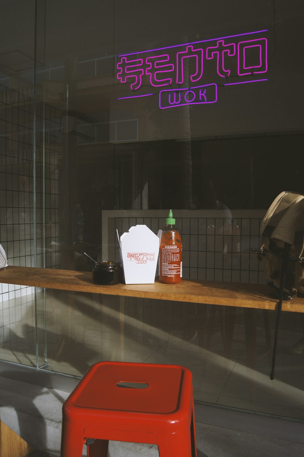 white and red plastic cup on brown wooden table