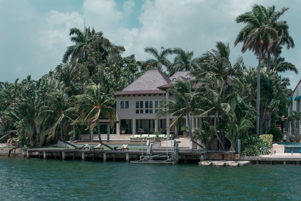 brown and white wooden house near body of water during daytime