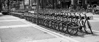 grayscale photo of bicycle parked on sidewalk