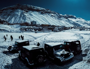 black and gray tractor on snow covered ground during daytime