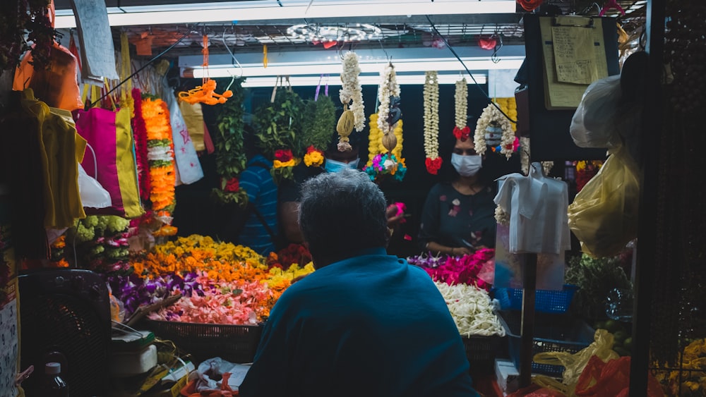 people standing in front of flowers during daytime