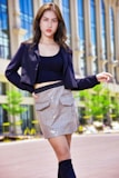 A model showcasing a chic outfit in an urban setting.