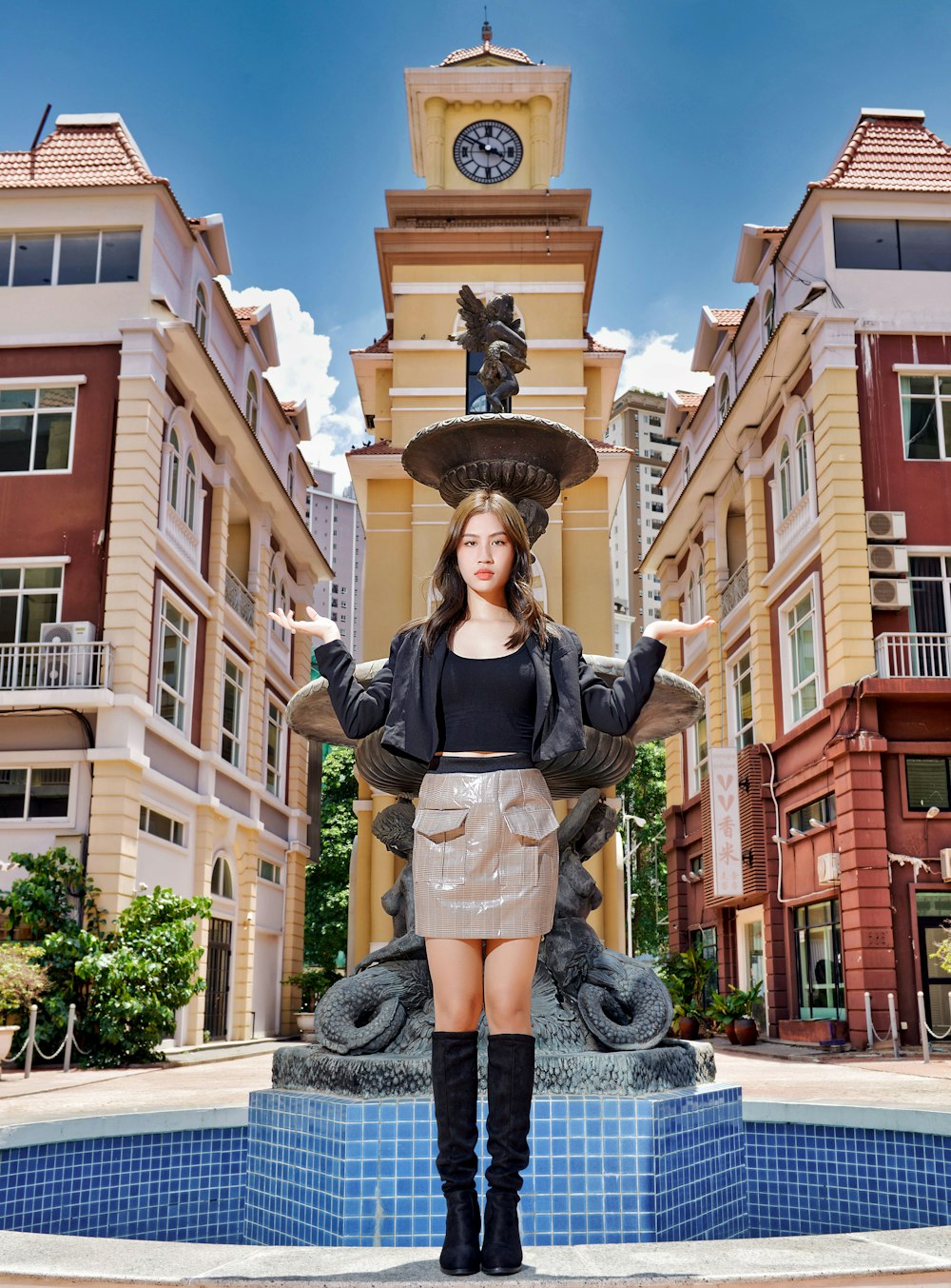 woman in black long sleeve shirt and black skirt standing on gray concrete floor during daytime