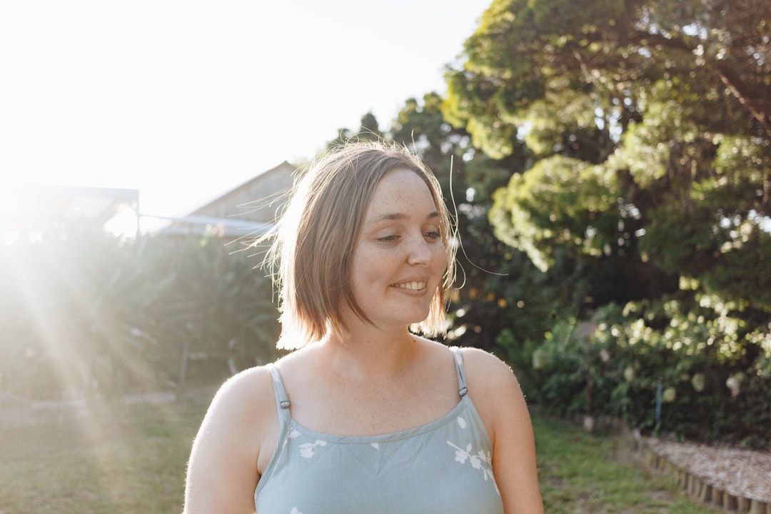 woman in white tank top smiling