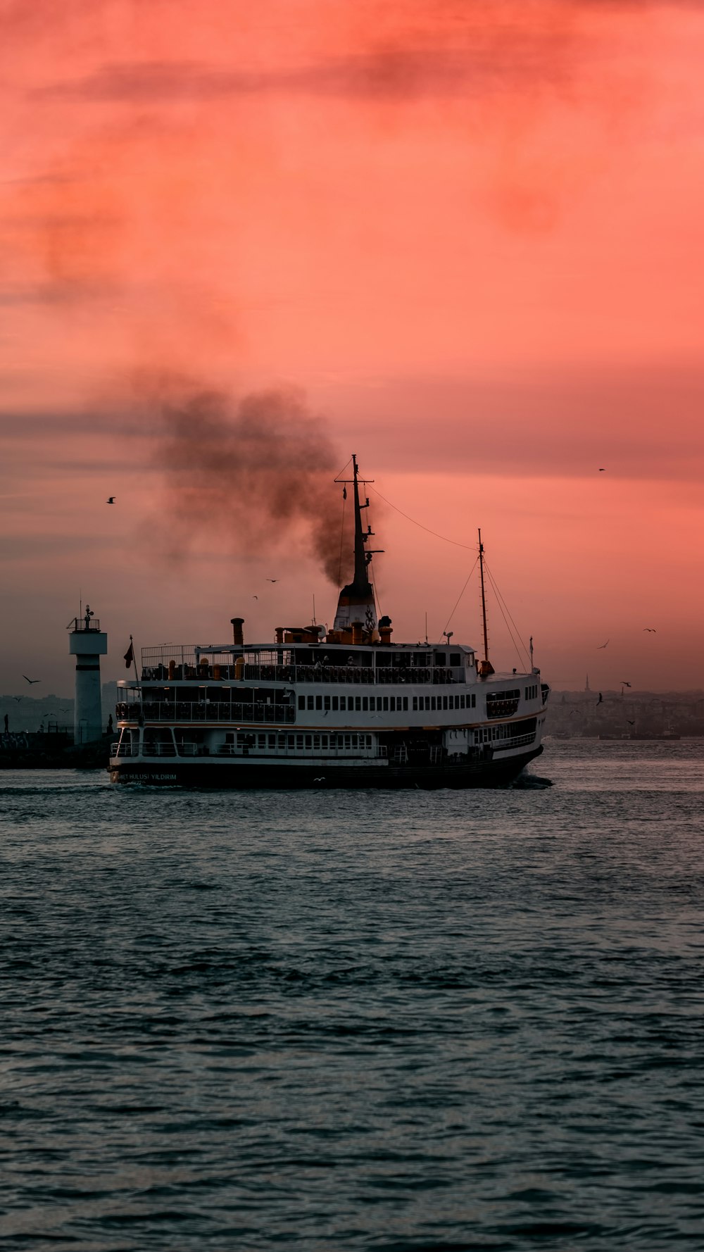 white ship on sea during sunset