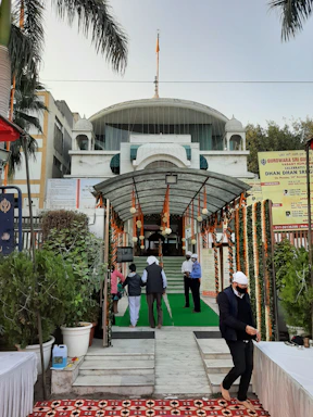 A welcoming office entrance with the Gurmukh Trust logo and friendly staff ready to assist visitors.
