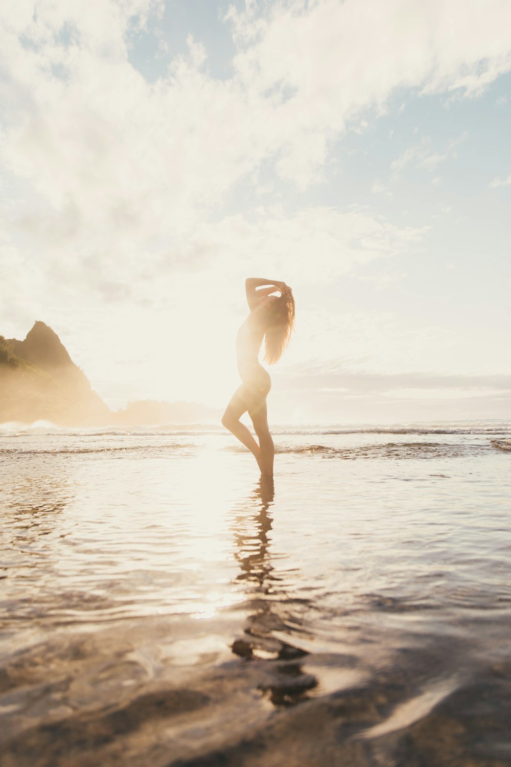 woman in white bikini standing on beach during daytime