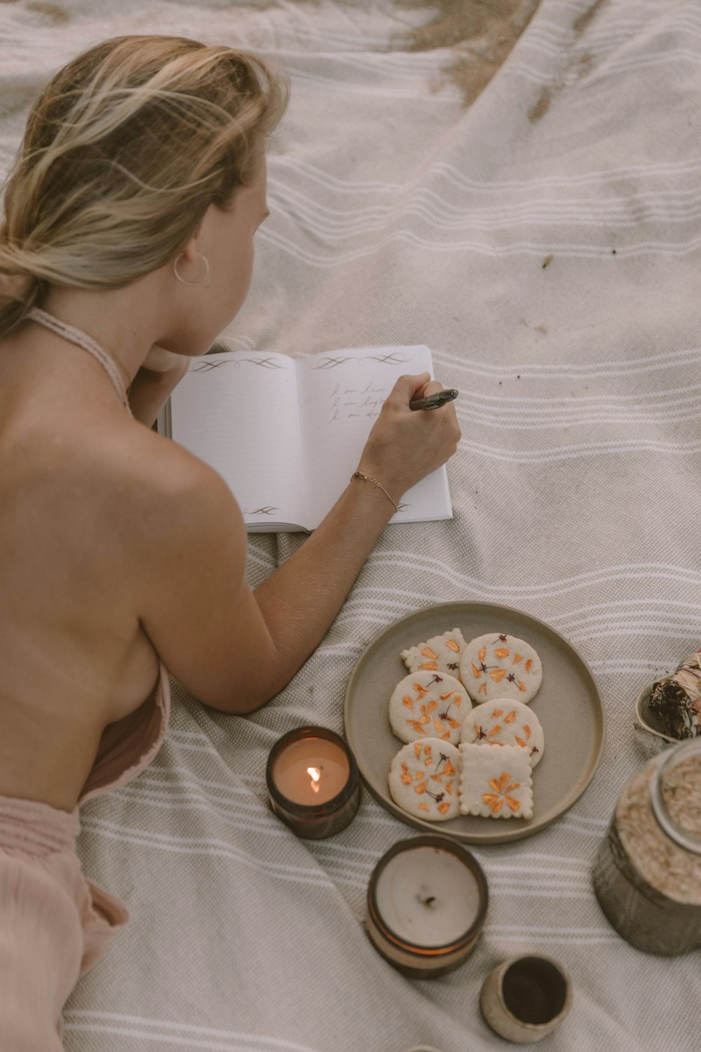 woman in white towel holding white ceramic plate with food