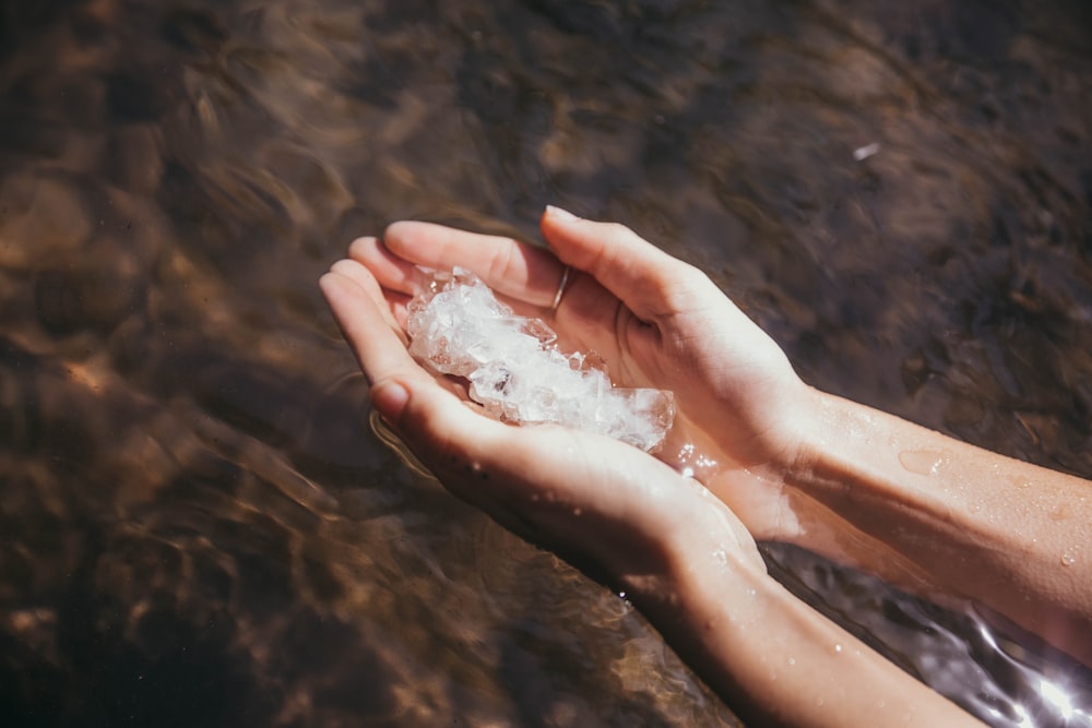 persons hand on water