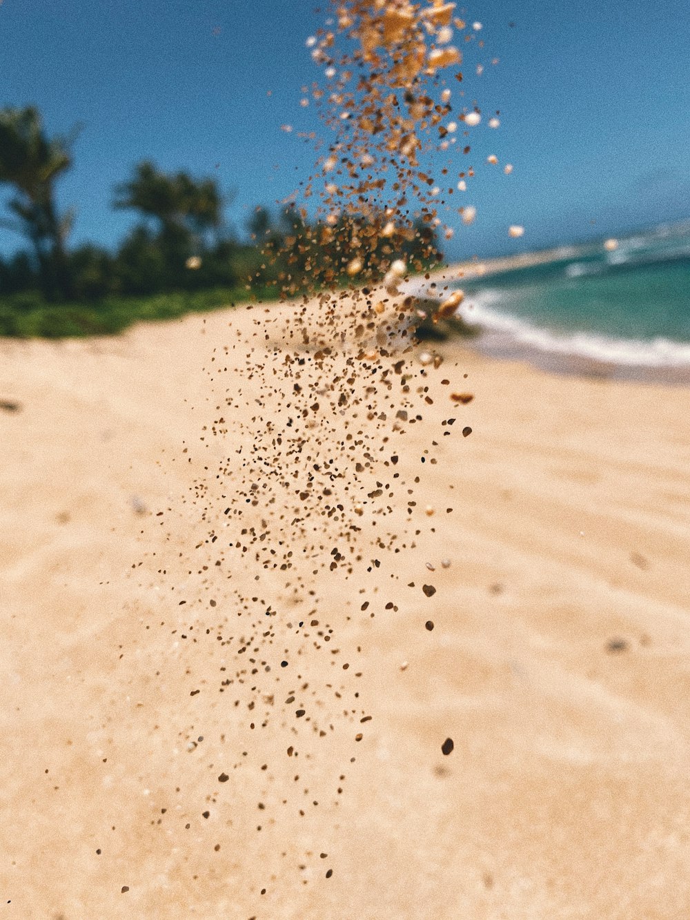 water splash on brown sand during daytime