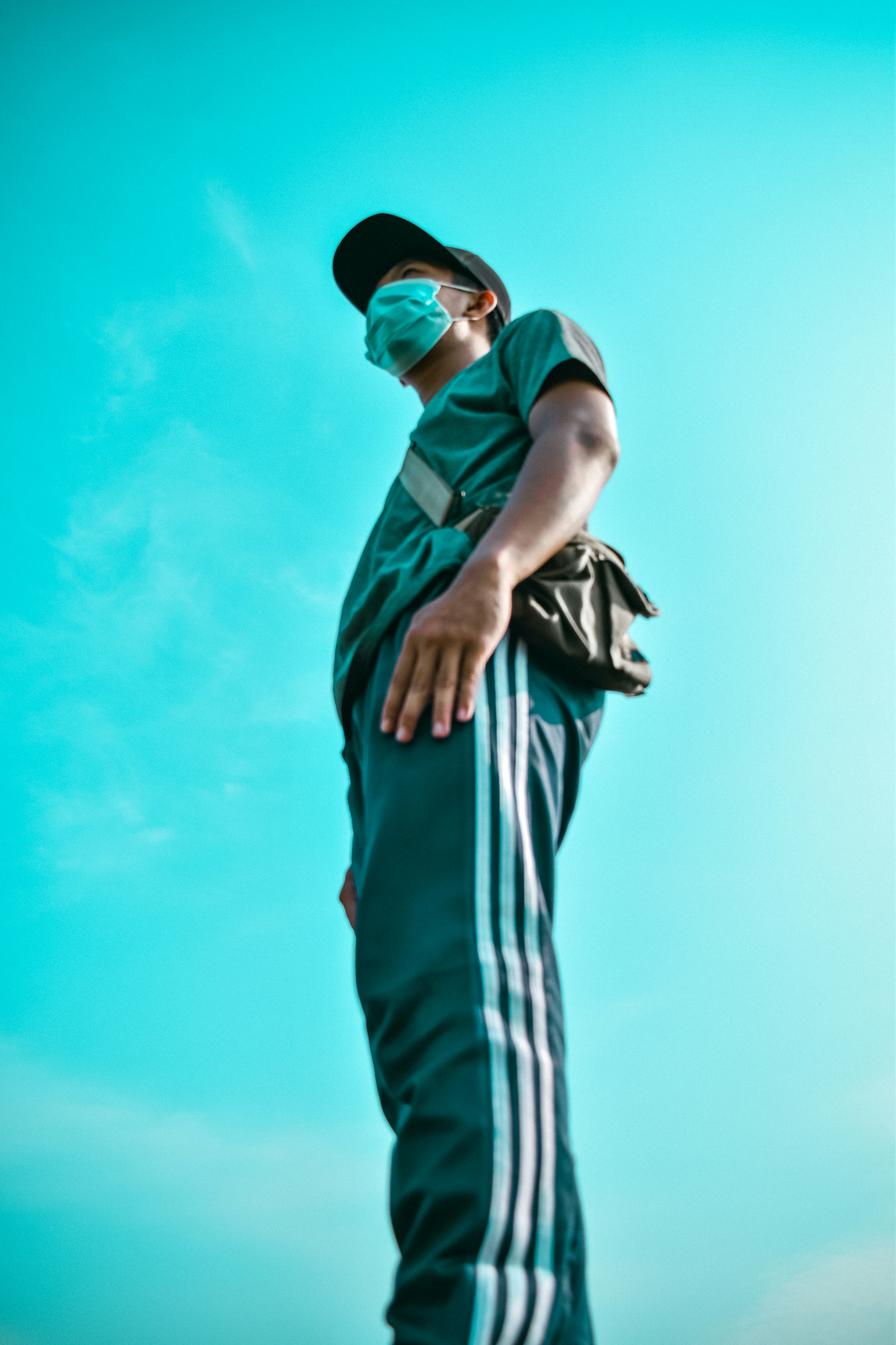man in green shirt and white and red striped pants