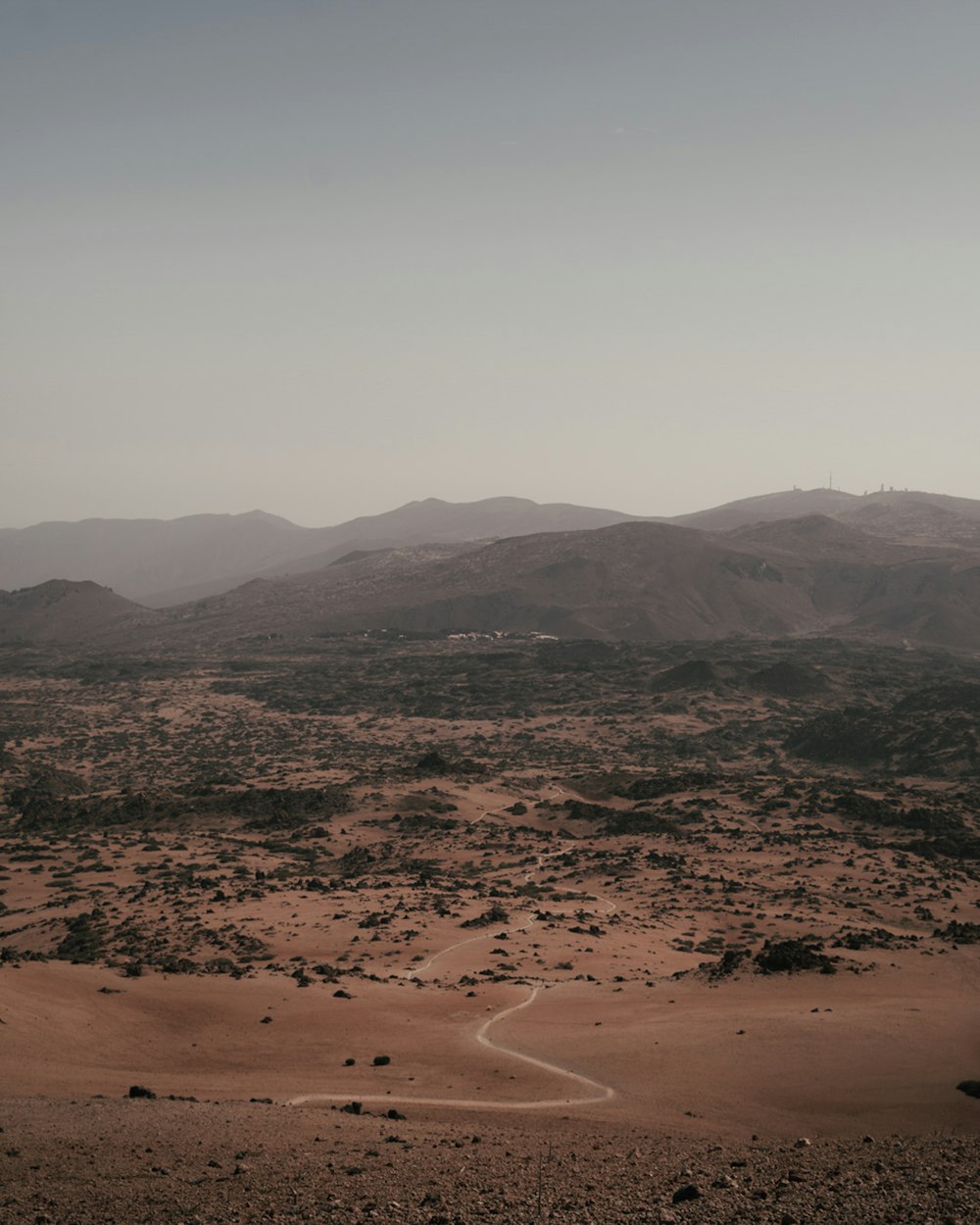 brown field and mountains during daytime