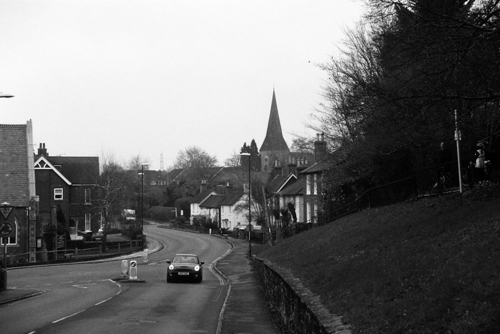 grayscale photo of cars parked on side of road