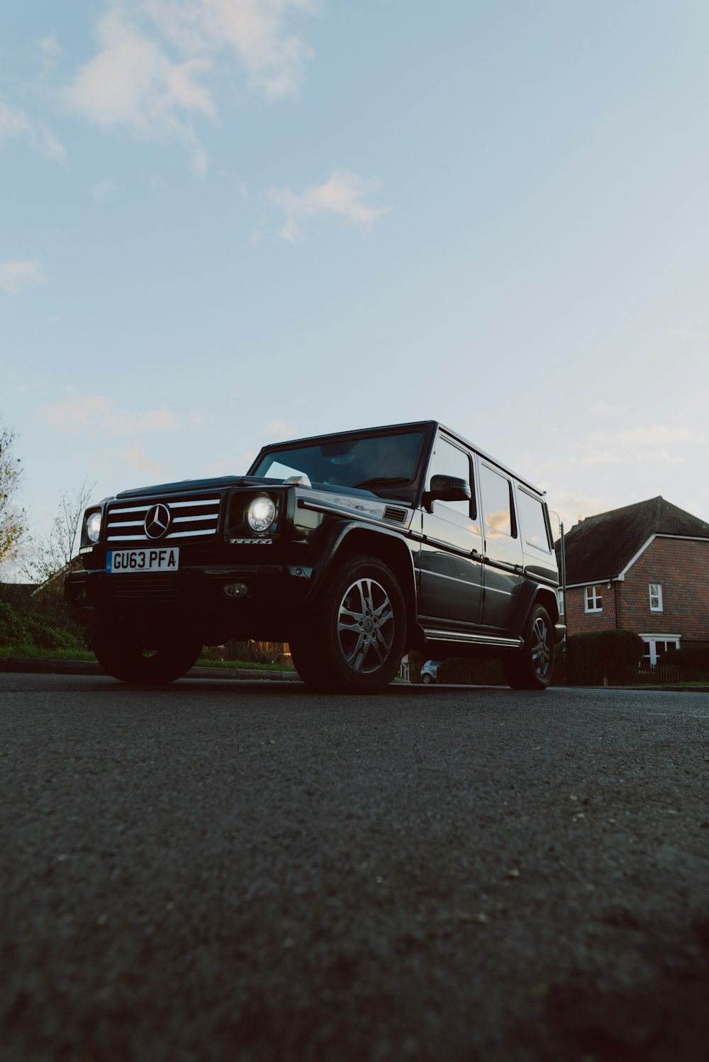 black mercedes benz g class on road during daytime