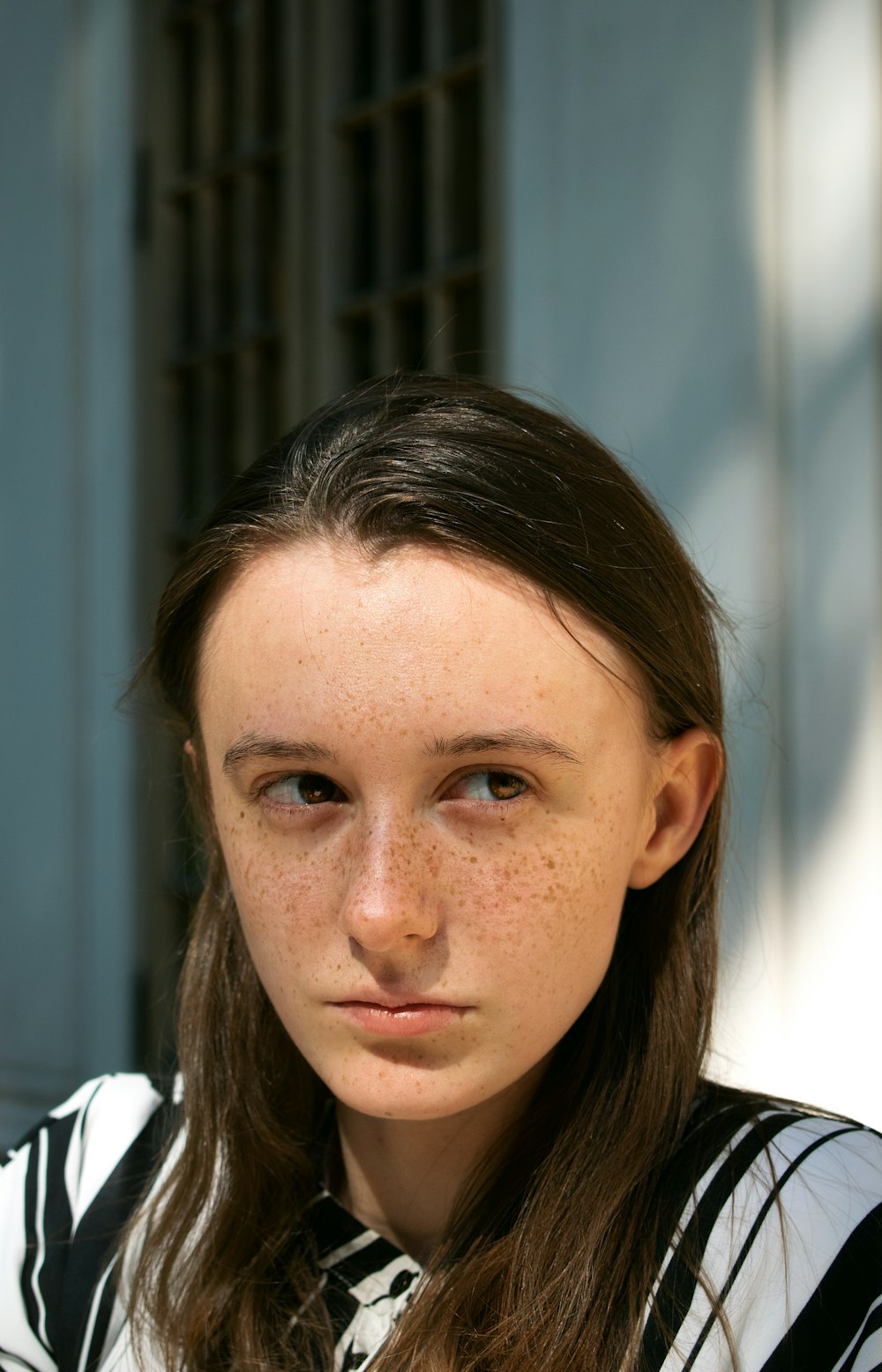 woman in white shirt looking down