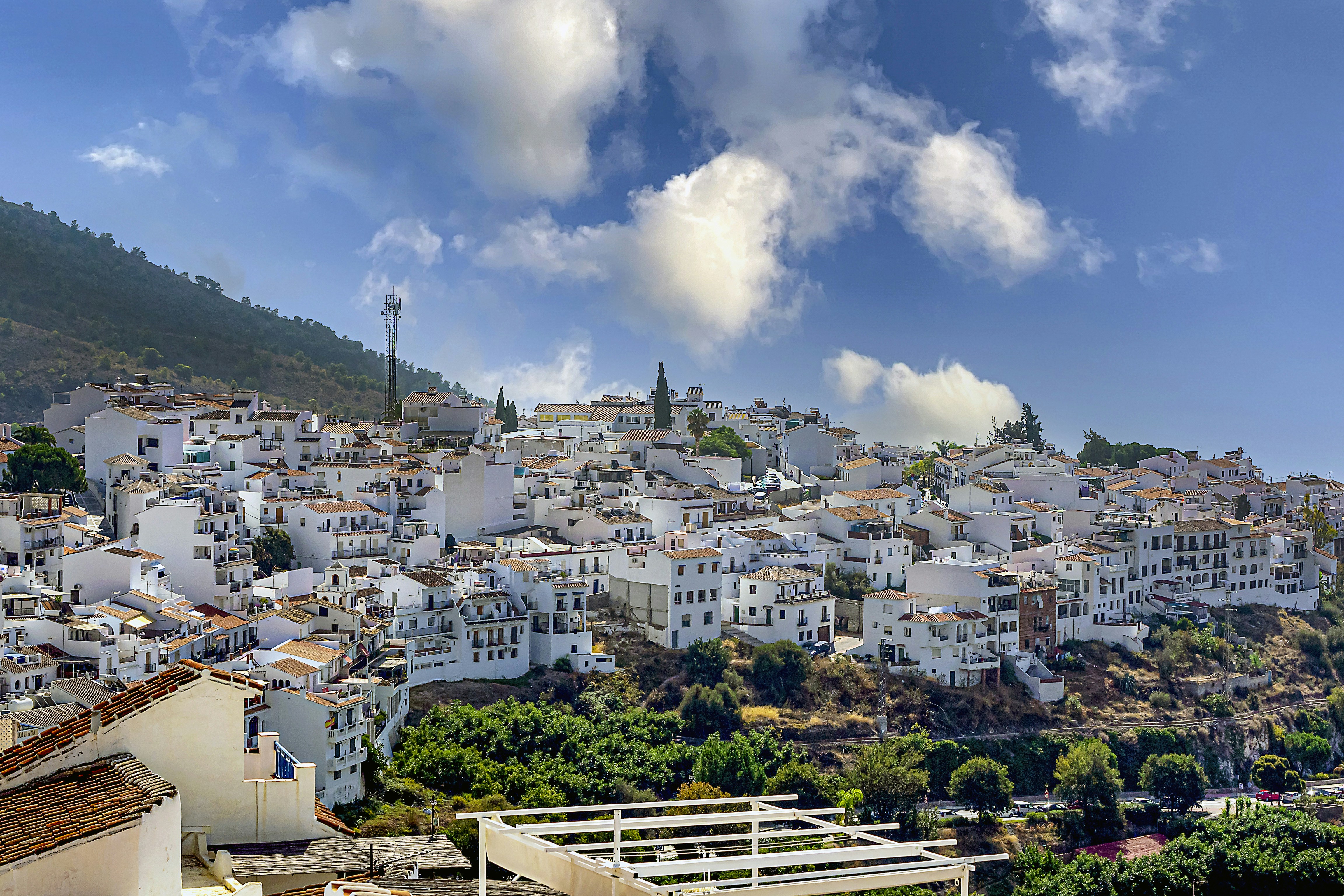 white and brown concrete buildings under blue sky and white clouds during daytime, Vista del pueblo de Figriliana, Malaga, España