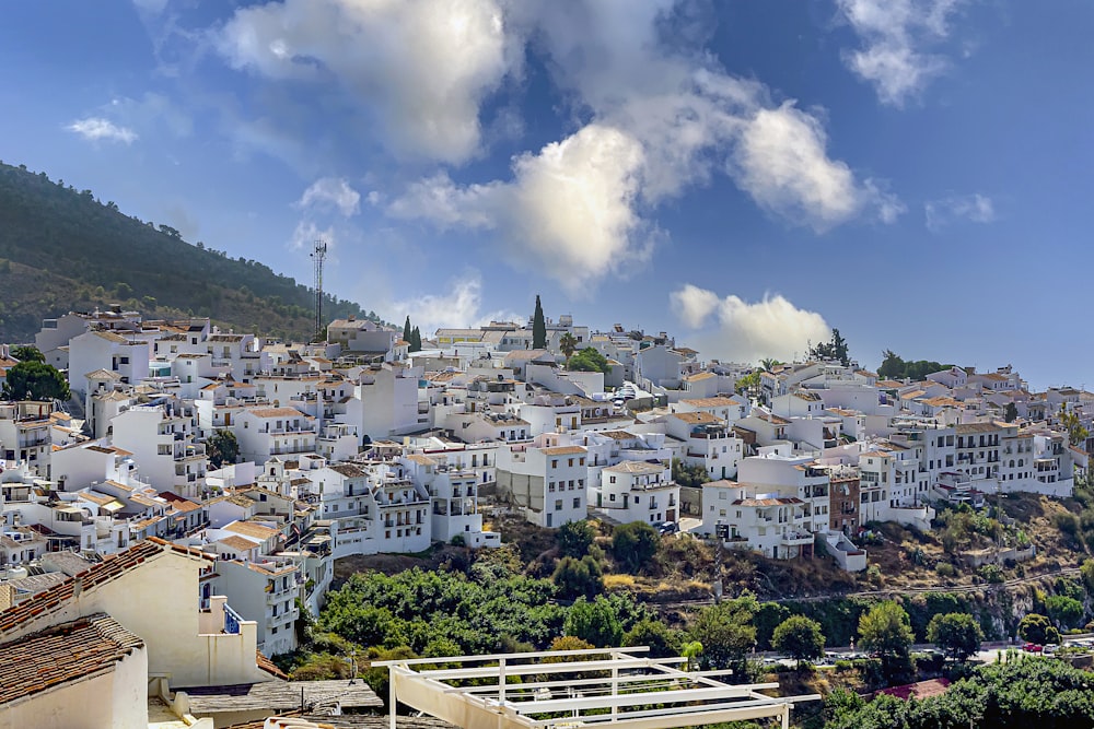 white and brown concrete buildings under blue sky and white clouds during daytime