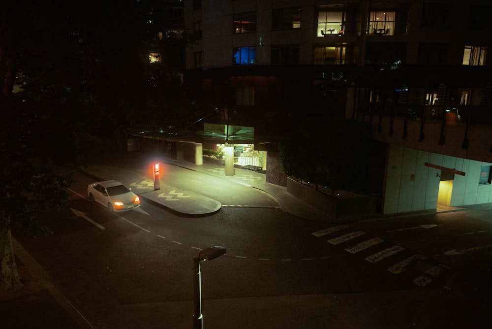 white car on road during night time