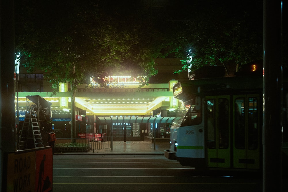 white and green tram on road during night time