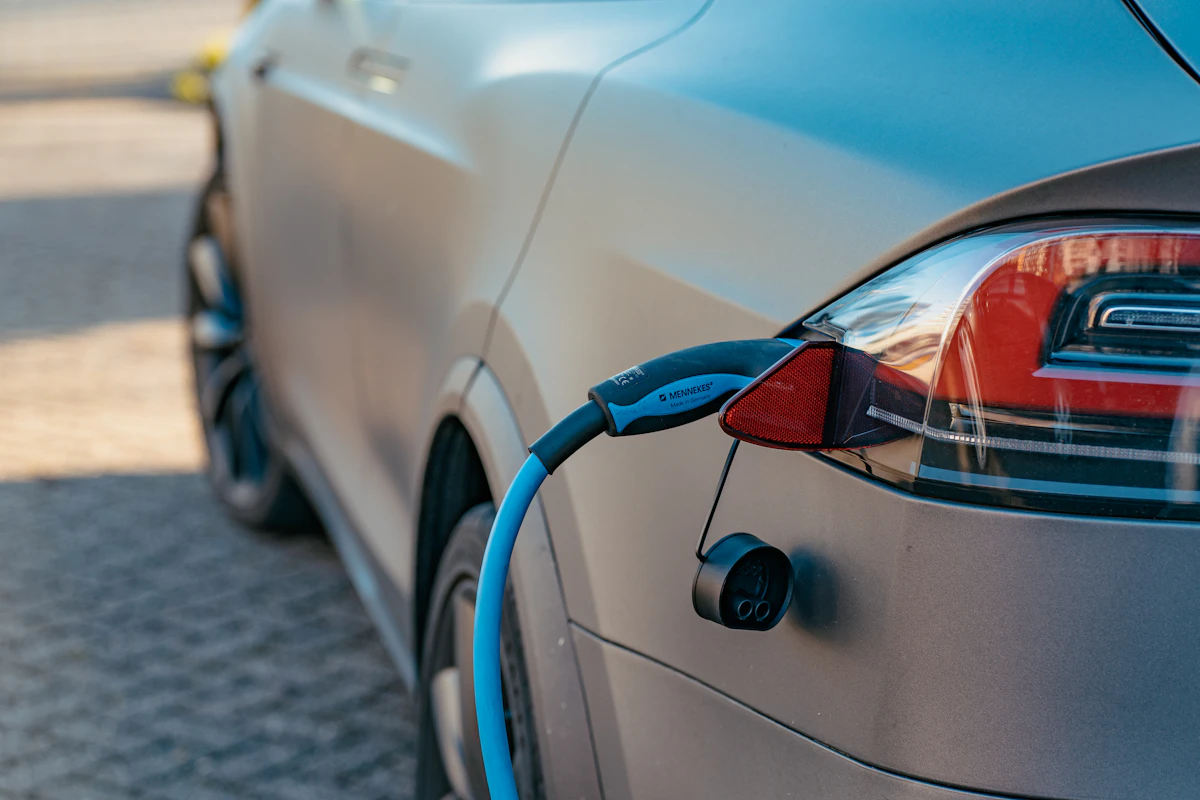 Electric vehicle charging cable connected to a car