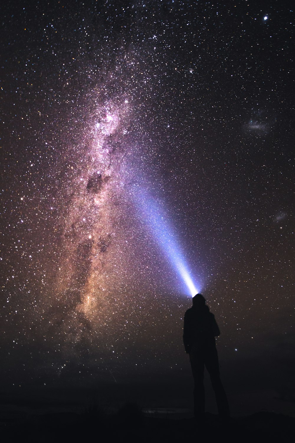 silhouette of man and woman under starry night