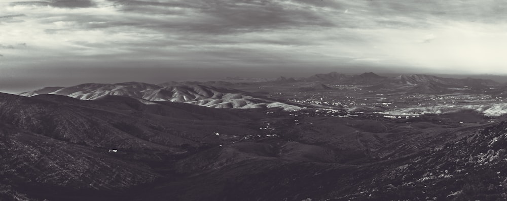 snow covered mountains under cloudy sky during daytime