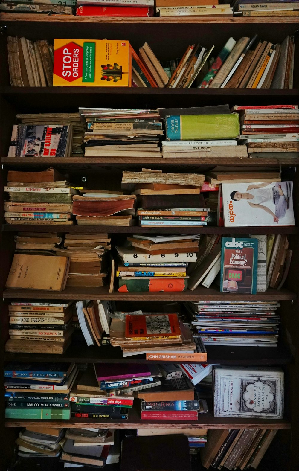 books on brown wooden shelf