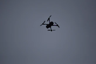 High-tech military drone flying over a dark, stormy sky symbolizing advanced aerial defense.